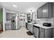 Bright kitchen featuring gray cabinets, stainless steel appliances, and tiled backsplash at 168 Saint Christopher Circle, Pawleys Island, SC 29585
