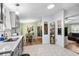 Bright kitchen with white countertops and gray cabinets, adjacent to dining area at 168 Saint Christopher Circle, Pawleys Island, SC 29585