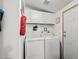 Bright laundry room with appliances, cabinets, shelving, and neutral walls at 168 Saint Christopher Circle, Pawleys Island, SC 29585