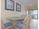 Dining area with seating for four and access to a balcony with ocean views at 1709 S Ocean Blvd. # 608, North Myrtle Beach, SC 29582