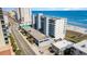Aerial view of building on the beach, parking and streets surround it, and ocean views at 1709 S Ocean Blvd. # 608, North Myrtle Beach, SC 29582