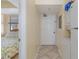 Hallway with front door, tile floor, and laundry area at 1709 S Ocean Blvd. # 608, North Myrtle Beach, SC 29582