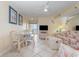 Cozy condo living room with dining area, ceiling fan, and water views at 1709 S Ocean Blvd. # 608, North Myrtle Beach, SC 29582