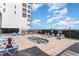 Exterior shot of a hot tub at a building with several people relaxing and enjoying the community amenity at 1709 S Ocean Blvd. # 608, North Myrtle Beach, SC 29582