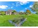 Expansive backyard featuring a manicured lawn, mature trees, and decorative fencing at 178 Kessinger Dr., Surfside Beach, SC 29575