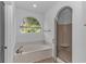 Luxurious bathroom with soaking tub, large window, and glass-enclosed shower at 178 Kessinger Dr., Surfside Beach, SC 29575