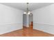 Dining room featuring hardwood flooring, crown molding, and an elegant chandelier at 178 Kessinger Dr., Surfside Beach, SC 29575