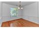 Well-lit dining room features wood floors, a modern chandelier, and updated trim at 178 Kessinger Dr., Surfside Beach, SC 29575