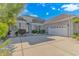 Beautiful single-Gathering home with mature landscaping, arched doorway, and three-car garage at 178 Kessinger Dr., Surfside Beach, SC 29575