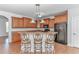 Kitchen area with breakfast bar, wood cabinets, stone countertops, and tile floors at 178 Kessinger Dr., Surfside Beach, SC 29575