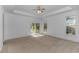 Expansive main bedroom with tray ceilings, a ceiling fan, and glass door leading to yard at 178 Kessinger Dr., Surfside Beach, SC 29575