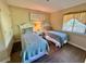 Bright second bedroom features twin beds, bedside table, and good natural light at 180 Rothbury Circle # 116, Myrtle Beach, SC 29572