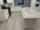 Bright kitchen features an island with white cabinets, granite countertops, and stainless steel appliances at 190 Glengrove Lane, Murrells Inlet, SC 29576