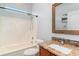 Bathroom featuring a shower/tub and granite vanity with decorative mirror at 197 Northside Dr., Little River, SC 29566