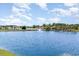Scenic pond view with fountain and waterfront homes in a tranquil community setting under a bright, partly cloudy sky at 197 Northside Dr., Little River, SC 29566