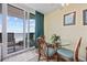 Cozy dining area with glass table and balcony access offering beautiful ocean views at 200 76Th Ave. N # 1009, Myrtle Beach, SC 29572