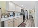 Well-equipped kitchen features stainless steel appliances, light wood cabinets, quartz countertops and wood look flooring at 200 76Th Ave. N # 1009, Myrtle Beach, SC 29572