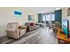 Cozy living room with comfortable seating, a dining area, and a sliding glass door to a balcony overlooking the ocean at 200 76Th Ave. N # 1009, Myrtle Beach, SC 29572