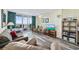 Inviting living room with cozy furnishings, an entertainment center, and balcony access with ocean views at 200 76Th Ave. N # 1009, Myrtle Beach, SC 29572