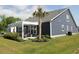 Beautiful backyard featuring a covered patio, landscaped yard, and a palm tree at 2005 Tiller Ct., Myrtle Beach, SC 29579