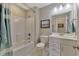 A clean bathroom featuring a shower-tub combo, a white vanity, and neutral color scheme at 2005 Tiller Ct., Myrtle Beach, SC 29579