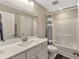 Bright bathroom with white cabinets, large mirror, shower and tub combination at 2005 Tiller Ct., Myrtle Beach, SC 29579