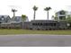 Stone entrance sign for the Harborview community, framed by palm trees and lush landscaping at 2005 Tiller Ct., Myrtle Beach, SC 29579