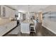 Bright, spacious kitchen with white cabinetry, granite countertops, stainless steel appliances, and a large island with barstool seating at 2005 Tiller Ct., Myrtle Beach, SC 29579