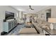 Open-concept living room with stylish decor, a large sofa, and a seamless flow into the kitchen area at 2005 Tiller Ct., Myrtle Beach, SC 29579