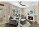 Cozy living room with comfortable armchairs, fireplace, natural light from the window, and elegant decor at 2005 Tiller Ct., Myrtle Beach, SC 29579