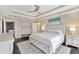 Main bedroom featuring a tray ceiling, ceiling fan, ensuite, and modern decor at 2005 Tiller Ct., Myrtle Beach, SC 29579