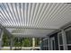 Stylish white louvered patio cover creates a comfortable outdoor living space with a modern design and adjustable shade at 2005 Tiller Ct., Myrtle Beach, SC 29579