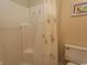 Bright bathroom with a white shower and a toilet under a fun beach themed art at 201 Landing Rd. # D, North Myrtle Beach, SC 29582