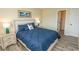 Comfortable bedroom boasts neutral decor, two nightstands, lamps, and a plush bed at 201 Landing Rd. # D, North Myrtle Beach, SC 29582