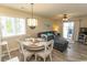 Open-concept dining area with modern lighting, a cozy table setting, and seamless access to the living space at 201 Landing Rd. # D, North Myrtle Beach, SC 29582