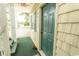 The home's entryway features a green door, a welcoming rug, and ample lighting for added charm at 201 Landing Rd. # D, North Myrtle Beach, SC 29582