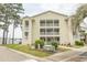 Inviting condo building with charming balconies, well-maintained landscaping, and ample parking at 201 Landing Rd. # D, North Myrtle Beach, SC 29582