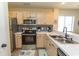 Charming kitchen with stainless appliances, patterned backsplash, and bright lighting creates a modern culinary space at 201 Landing Rd. # D, North Myrtle Beach, SC 29582
