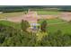 Aerial view of home on Hwy 308 highlighting its proximity to farmland, woods, and a serene pond at 2192 Highway 308, Galivants Ferry, SC 29544