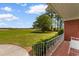 View of the backyard from the patio featuring green grass and trees, creating a serene outdoor setting at 2192 Highway 308, Galivants Ferry, SC 29544