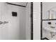 Updated bathroom features white tiles with black accents, a modern shower, and a stylish sink area at 2192 Highway 308, Galivants Ferry, SC 29544