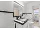 Bathroom with black and white tiles and retro sink and vanity at 2192 Highway 308, Galivants Ferry, SC 29544