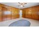 An empty room with wood paneling, a built-in closet, and an area rug on neutral flooring at 2192 Highway 308, Galivants Ferry, SC 29544