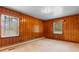 Wood-paneled bedroom with natural light streaming through the windows, creating a warm and inviting space at 2192 Highway 308, Galivants Ferry, SC 29544