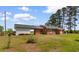Brick home with a well-manicured lawn, attached garage, and lovely landscaping, enhancing curb appeal at 2192 Highway 308, Galivants Ferry, SC 29544