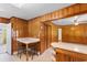 A cozy kitchen with wooden paneling, dining table, and an open doorway to the next room at 2192 Highway 308, Galivants Ferry, SC 29544