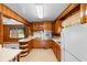 A kitchen featuring wood-paneled walls, light countertops, and essential appliances at 2192 Highway 308, Galivants Ferry, SC 29544