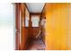 Functional mudroom with wooden walls and a tile floor, featuring storage and access to the outside at 2192 Highway 308, Galivants Ferry, SC 29544