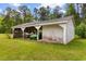 A storage shed with an overhang sits on a large lawn providing ample storage space for equipment and tools at 2192 Highway 308, Galivants Ferry, SC 29544