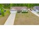 Aerial view of a well-kept single story home with a long driveway and an expansive, landscaped lawn at 247 Rolling Oak Dr., Georgetown, SC 29440